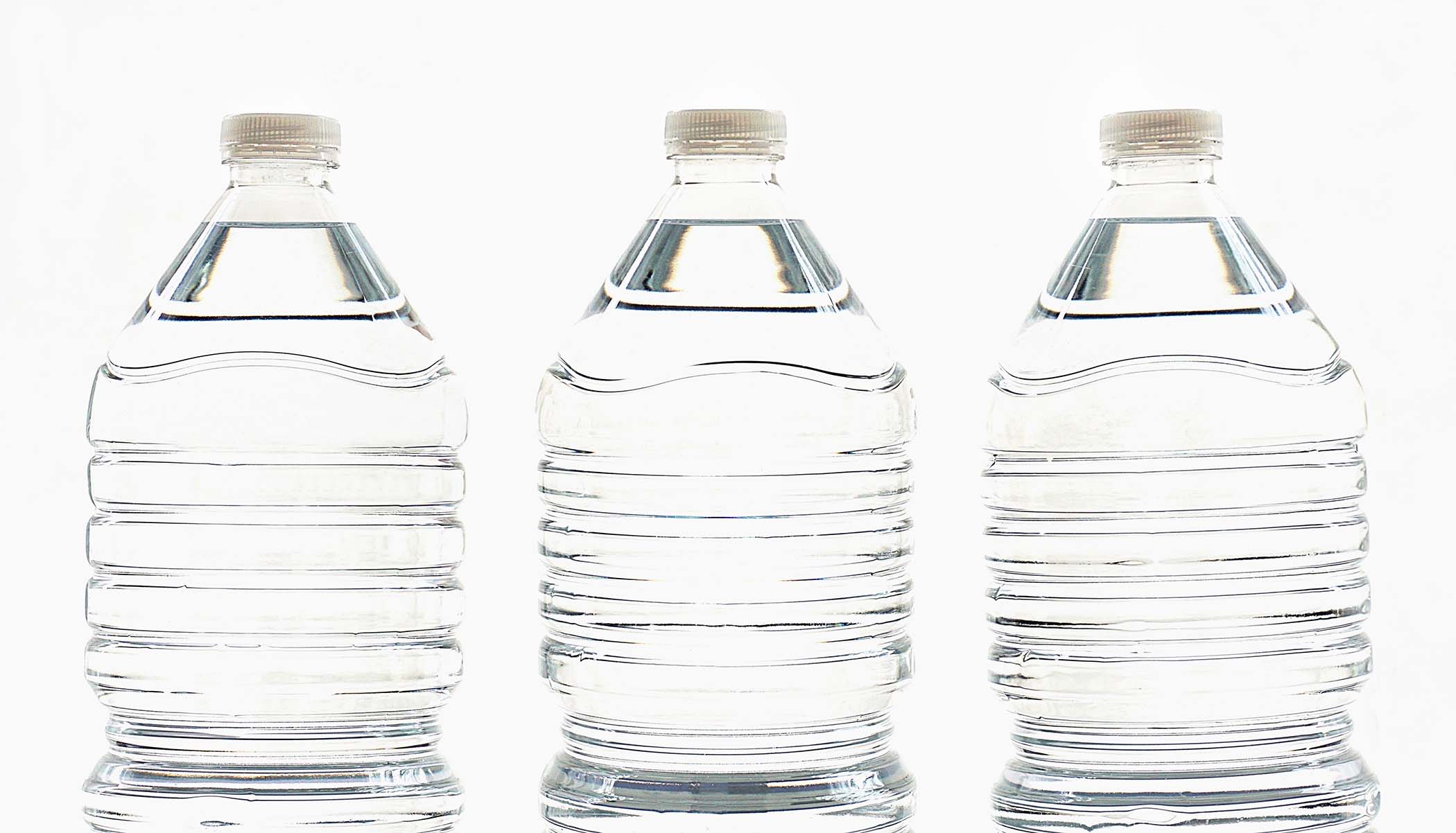 three plastic water bottles in a row